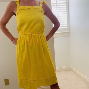 Bright yellow sleeveless dress.